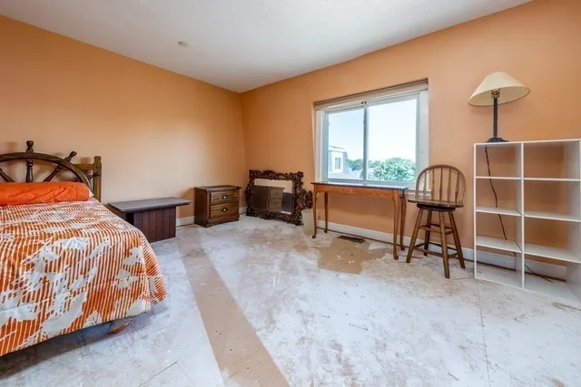 a bedroom with bed and a window