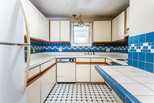 a kitchen with stainless steel appliances a sink and cabinets