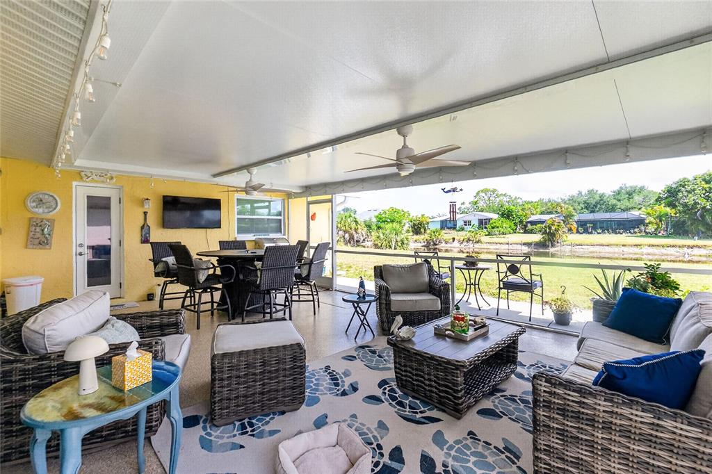 219 Caddy Road Rotonda West, FL 33947 - Photo 52 of 89 a living room with furniture and a large window