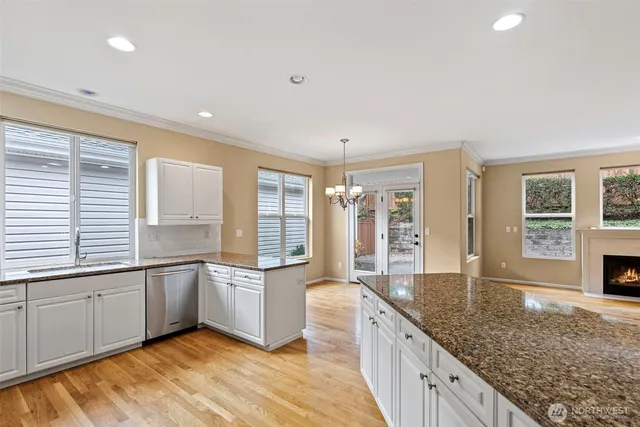a large kitchen with lot of counter space and windows
