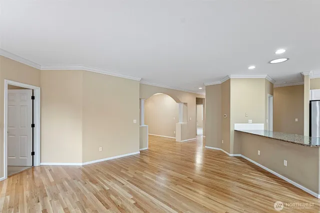 a view of empty room with wooden floor