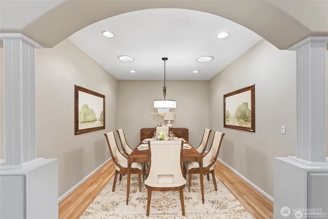a dining room with furniture a rug and wooden floor