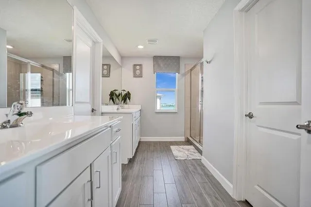 a spacious bathroom with a sink mirror and shower