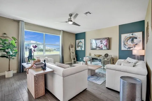 a living room with furniture and a large window