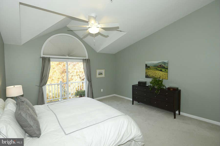 3052 South Glebe Road Arlington, VA 22206 - Photo 12 of 16 a bedroom with a bed and a chandelier