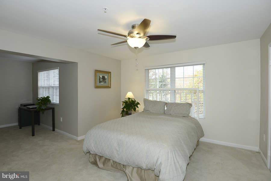 3052 South Glebe Road Arlington, VA 22206 - Photo 8 of 16 a bedroom with a large bed and a chandelier