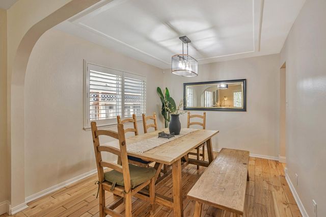 a view of a dining room with furniture and a chandelier