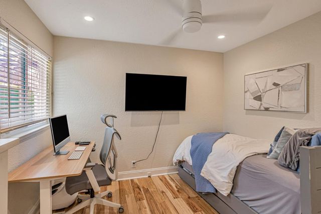 a bedroom with a bed and a flat screen tv