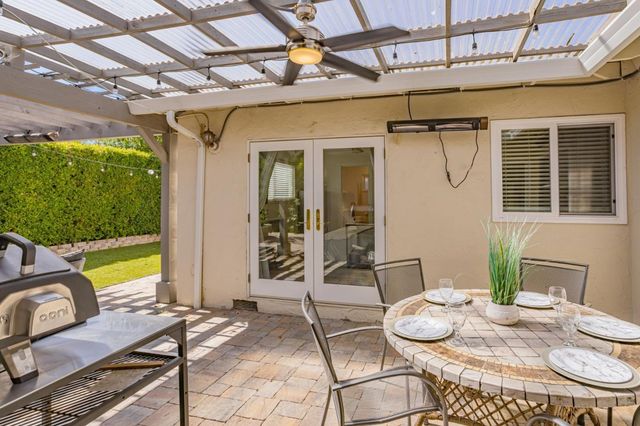 a view of a patio with table and chairs
