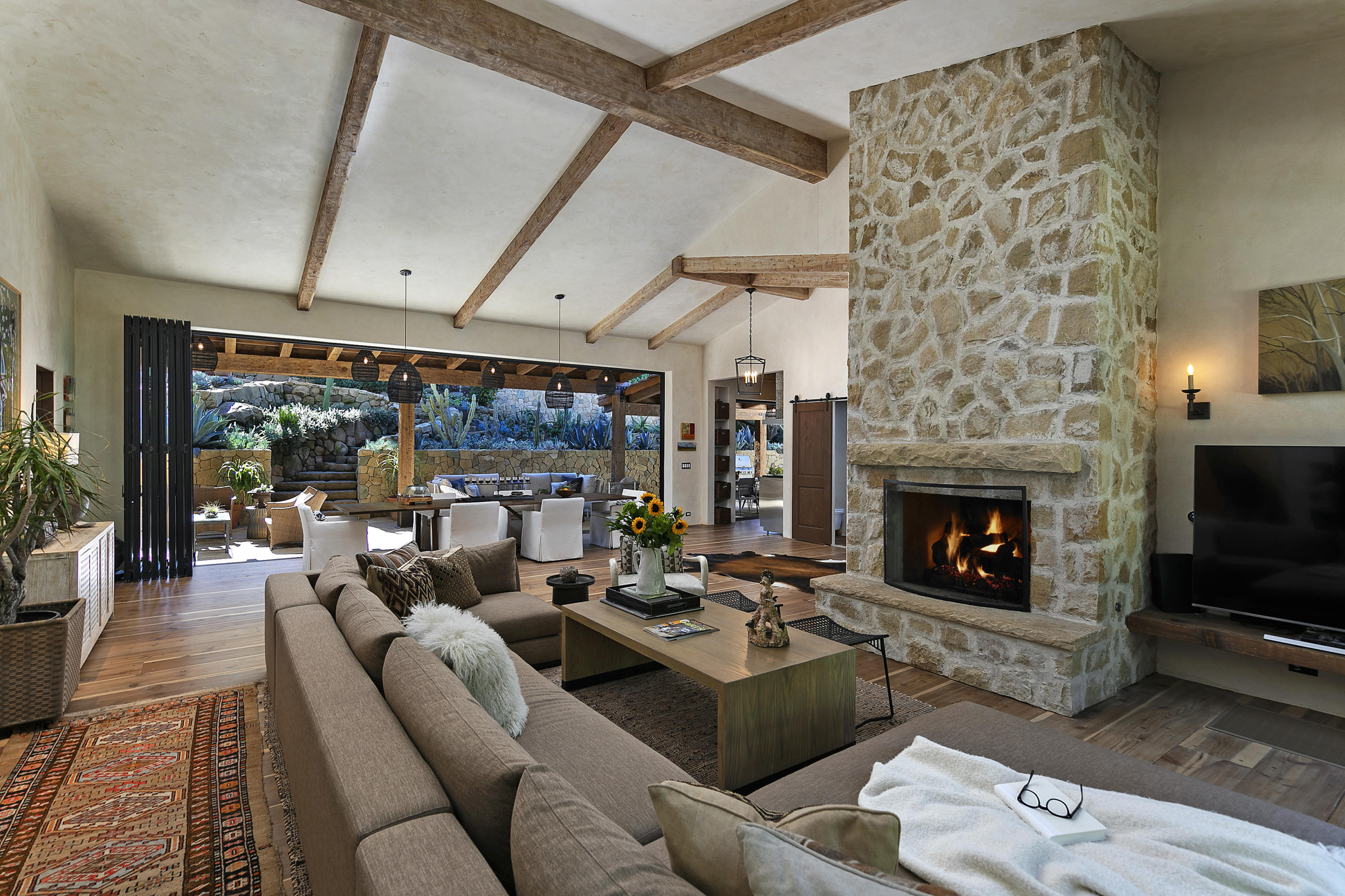 2255 Las Tunas Road Santa Barbara, CA 93103 - Photo 2 of 9 a living room with furniture large window and a fireplace