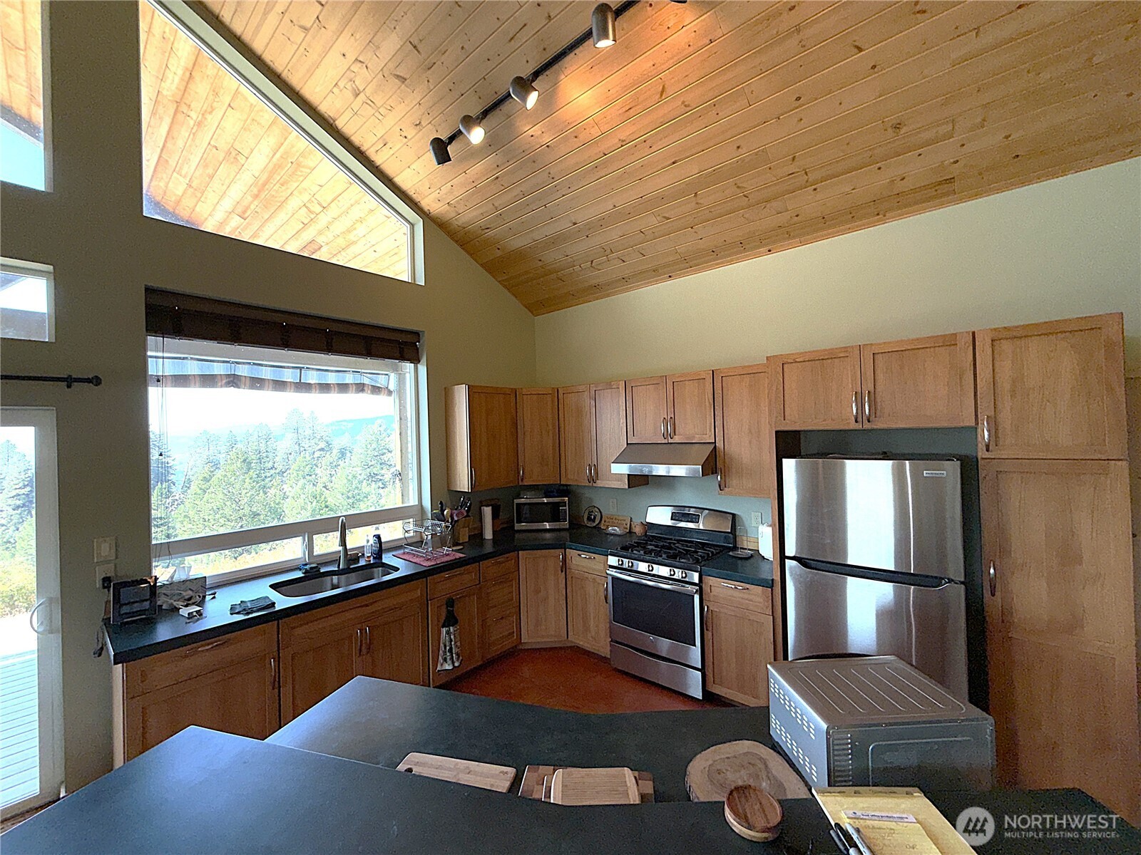 167 Excelsior Way Curlew, WA 99118 - Photo 5 of 37 a kitchen with stainless steel appliances granite countertop a refrigerator a stove and a sink with wooden floor