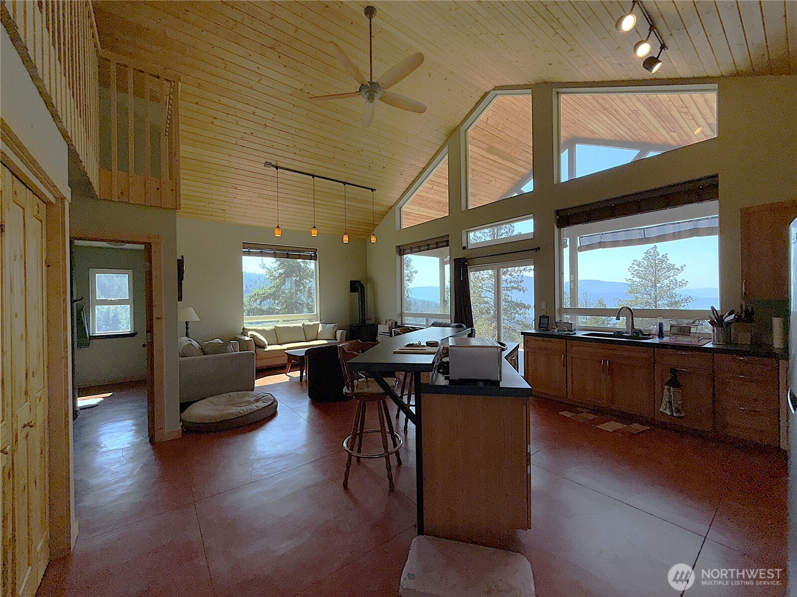 167 Excelsior Way Curlew, WA 99118 - Photo 8 of 37 a living room with furniture and a large window