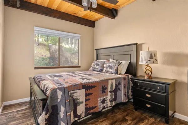 a bedroom with a bed next to a window