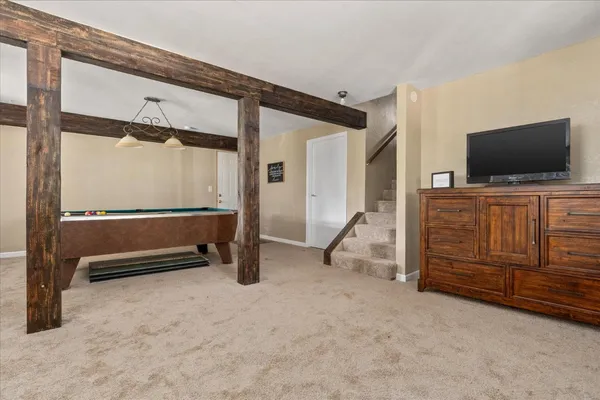 a bedroom with furniture and a flat screen tv