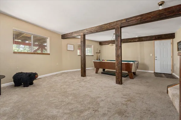 a living room with furniture and a air conditioner vent