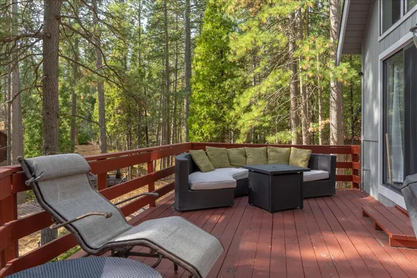 a balcony with wooden floor and furniture