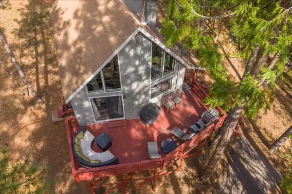 a backyard of a house with table and chairs