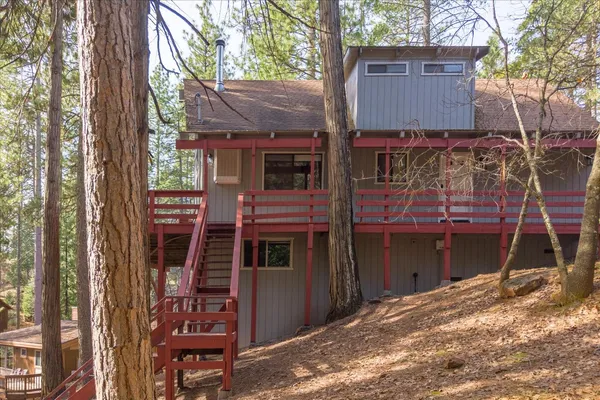 a view of a house with a tree beside it