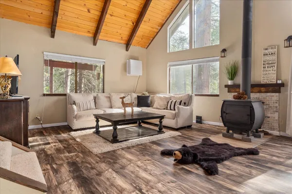 a living room with furniture a rug and a table