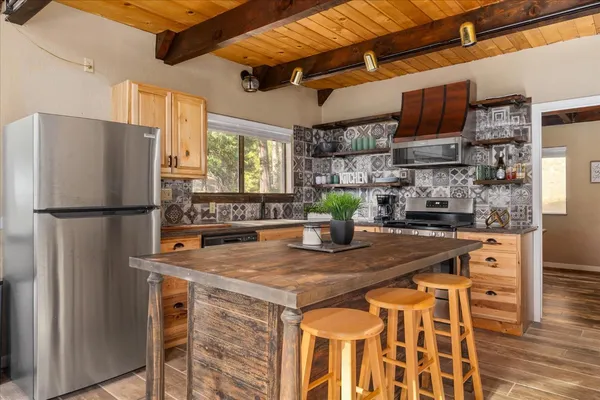 a kitchen with stainless steel appliances granite countertop a sink refrigerator and microwave