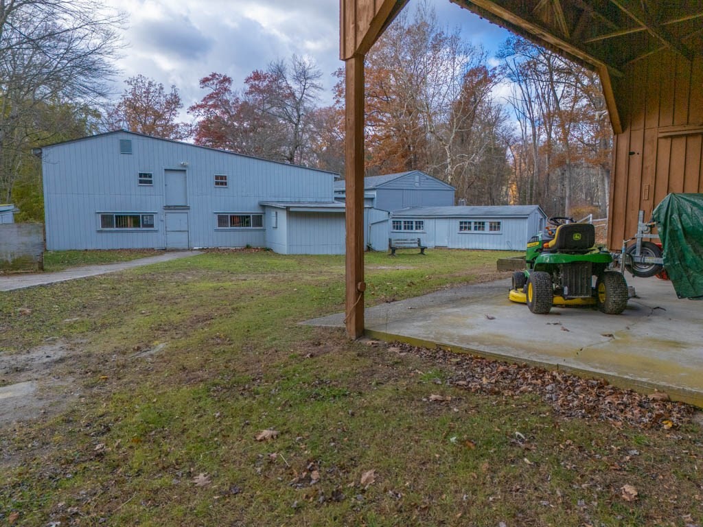 219-221 Peeptoad Road Scituate, RI 02857 - Photo 12 of 16 a backyard of a house with table and chairs
