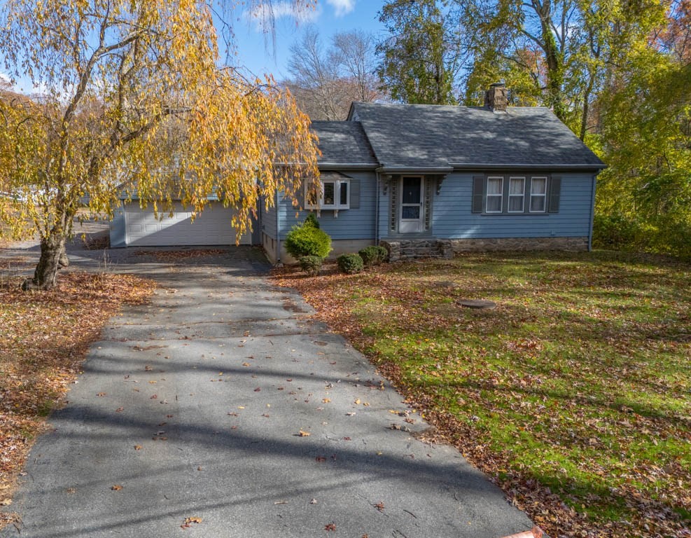 219-221 Peeptoad Road Scituate, RI 02857 - Photo 2 of 16 a front view of a house with a garden