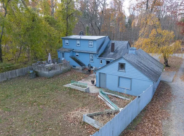 a view of a backyard with wooden fence