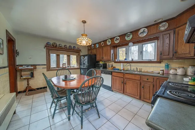 a large kitchen with a table and chairs