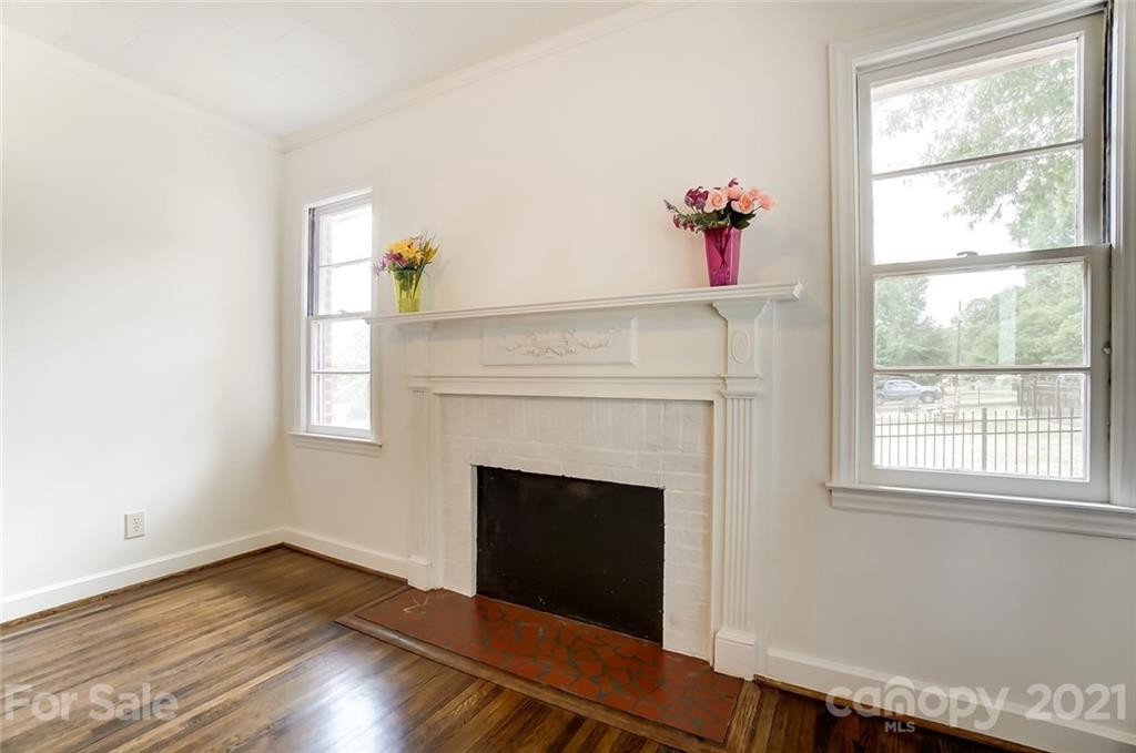 201 Lydia Street Monroe, NC 28110 - Photo 20 of 39 a living room with a fireplace and wooden floor