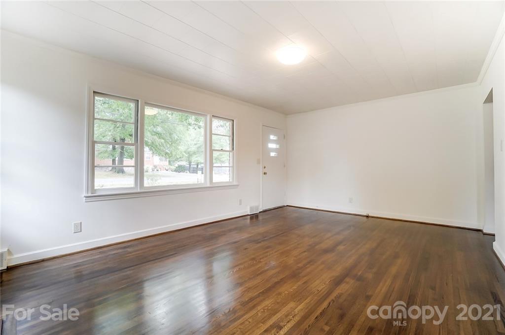 201 Lydia Street Monroe, NC 28110 - Photo 21 of 39 an empty room with wooden floor and windows