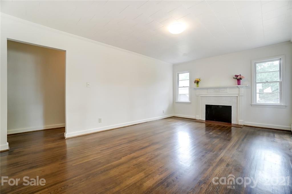 201 Lydia Street Monroe, NC 28110 - Photo 22 of 39 an empty room with wooden floor and fireplace