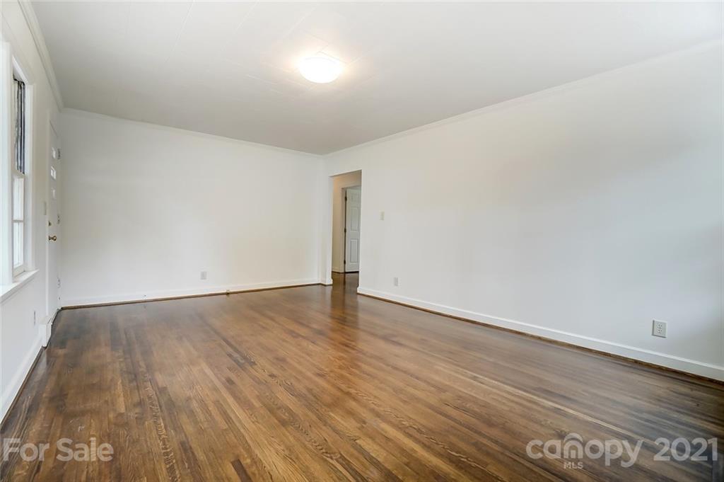 201 Lydia Street Monroe, NC 28110 - Photo 23 of 39 a view of an empty room with wooden floor and a window