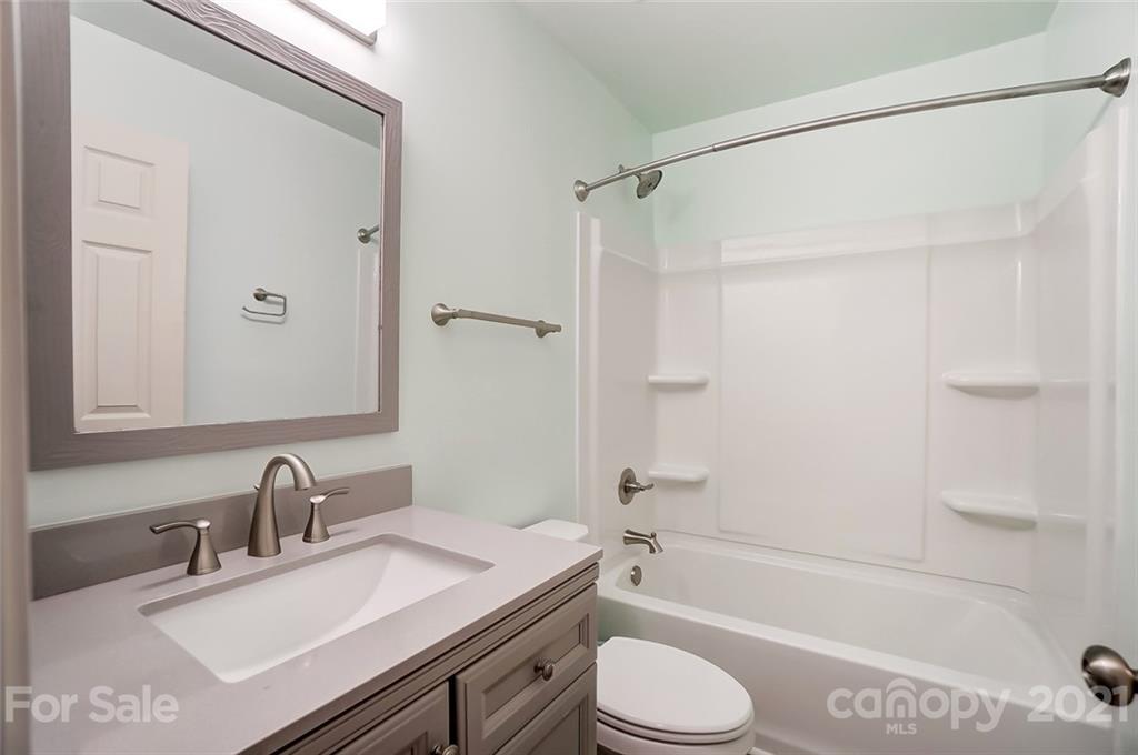 201 Lydia Street Monroe, NC 28110 - Photo 24 of 39 a bathroom with a granite countertop sink toilet and shower