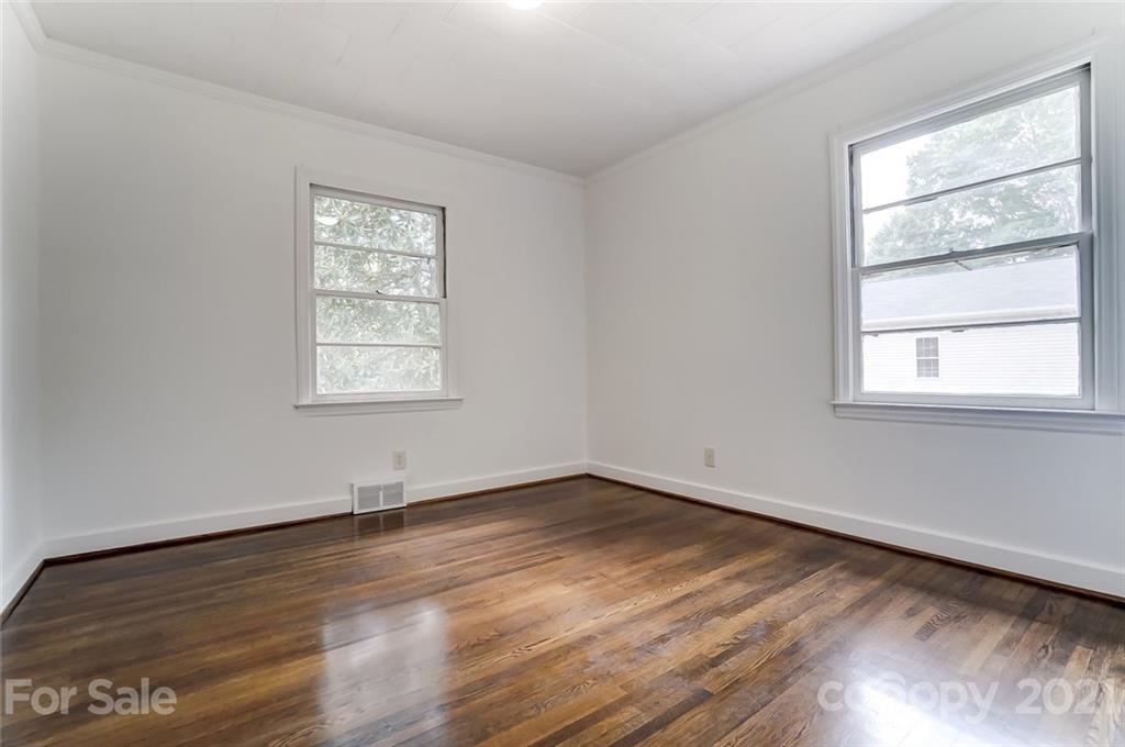 201 Lydia Street Monroe, NC 28110 - Photo 25 of 39 an empty room with wooden floor and windows