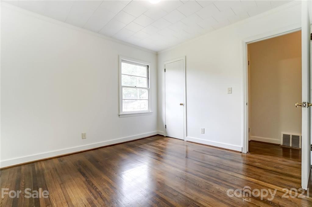 201 Lydia Street Monroe, NC 28110 - Photo 26 of 39 an empty room with wooden floor and windows