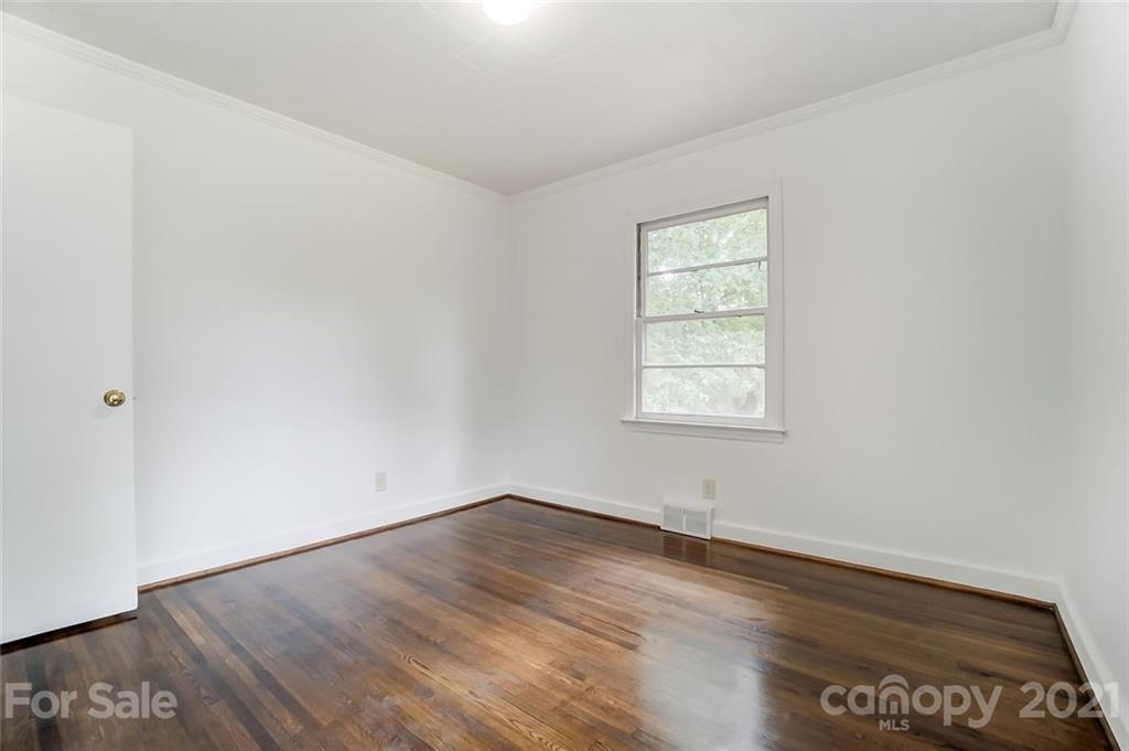 201 Lydia Street Monroe, NC 28110 - Photo 28 of 39 an empty room with wooden floor and windows