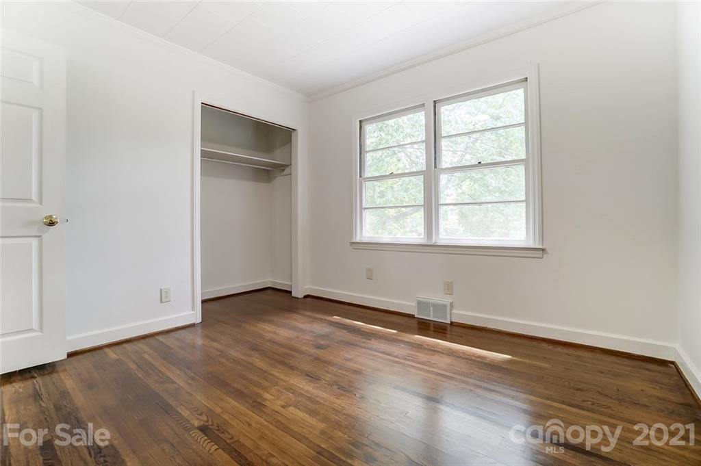 201 Lydia Street Monroe, NC 28110 - Photo 29 of 39 an empty room with wooden floor and windows