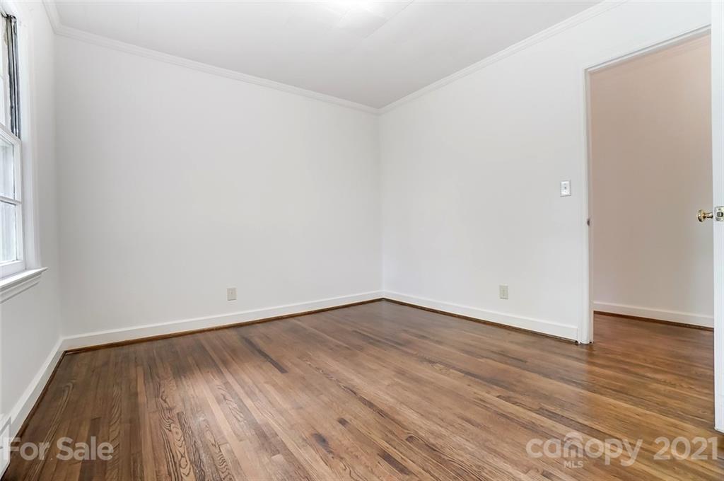 201 Lydia Street Monroe, NC 28110 - Photo 30 of 39 a view of an empty room with wooden floor and a window