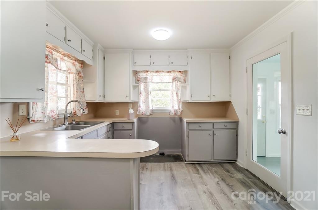 201 Lydia Street Monroe, NC 28110 - Photo 4 of 39 a kitchen with a sink cabinets appliances and a window