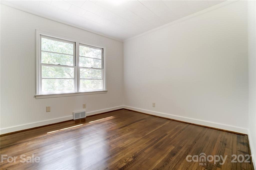 201 Lydia Street Monroe, NC 28110 - Photo 31 of 39 an empty room with wooden floor and windows