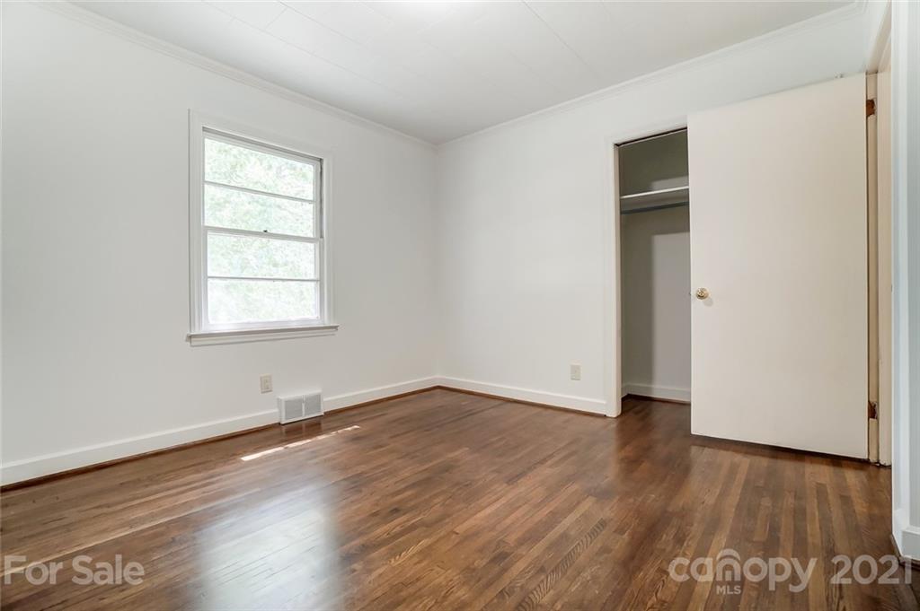 201 Lydia Street Monroe, NC 28110 - Photo 34 of 39 an empty room with wooden floor and windows
