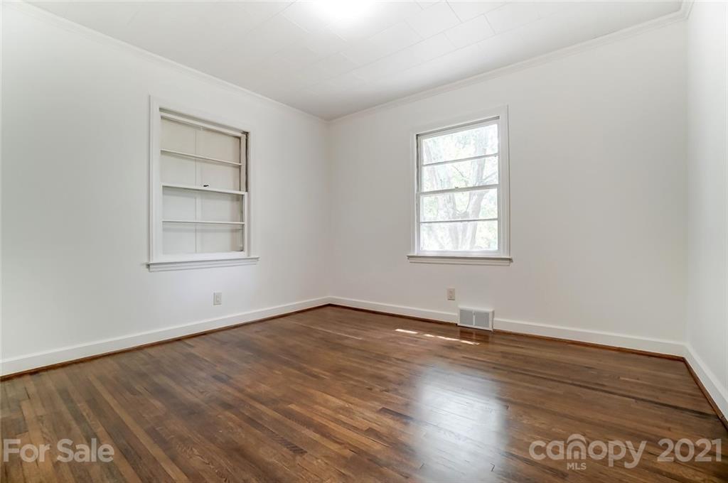 201 Lydia Street Monroe, NC 28110 - Photo 35 of 39 an empty room with wooden floor and windows
