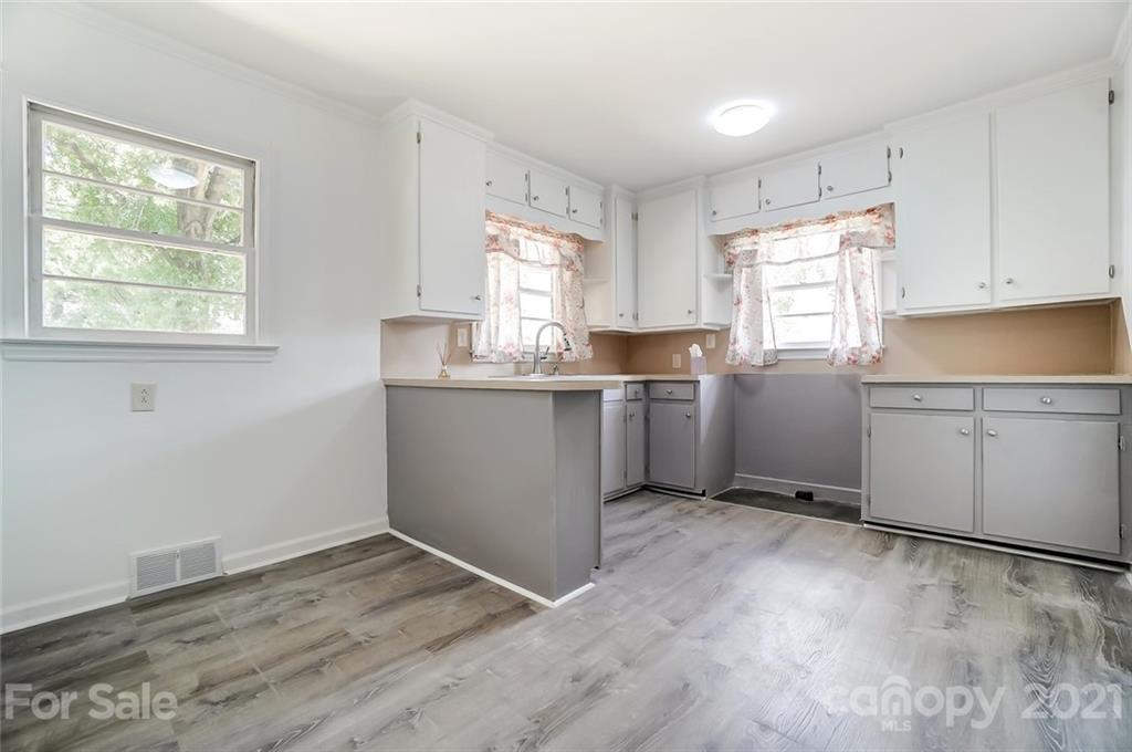 201 Lydia Street Monroe, NC 28110 - Photo 6 of 39 a kitchen with a cabinets and window