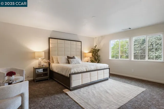 a bedroom with a bed and a couch