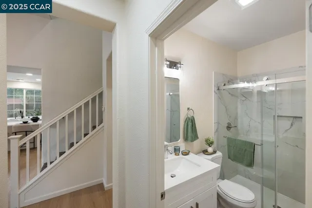 a bathroom with a sink mirror and shower