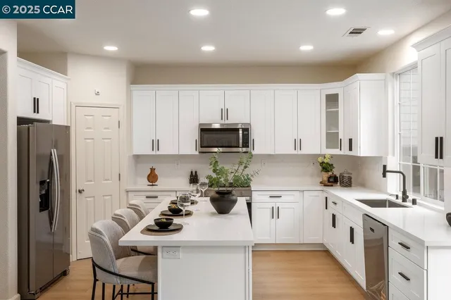a kitchen with a sink stove and refrigerator