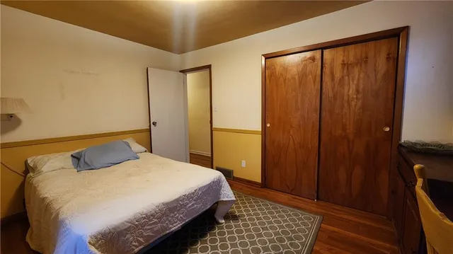 a bedroom with a bed and a desk