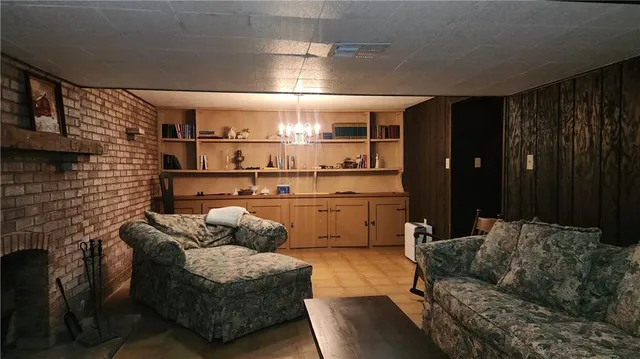 a living room with furniture a rug and a fireplace