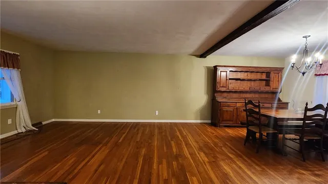 a view of room with furniture and wooden floor