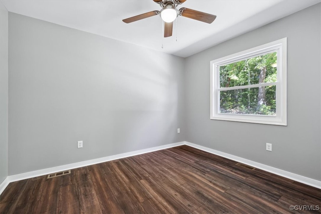 87 Proffits Road Louisa, VA 23093 - Photo 19 of 33 a view of an empty room with wooden floor and a window